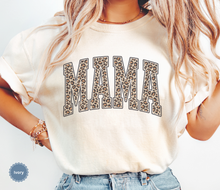 Load image into Gallery viewer, Folded ivory comfort colors t-shirt with 'MAMA' in leopard print.