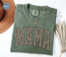 Load image into Gallery viewer, Folded moss green comfort colors t-shirt with 'MAMA' in leopard print.