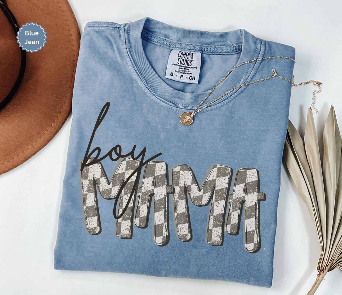 Folded blue jean colors comfort colors t-shirt with retro checkered 'BOY MAMA' text.