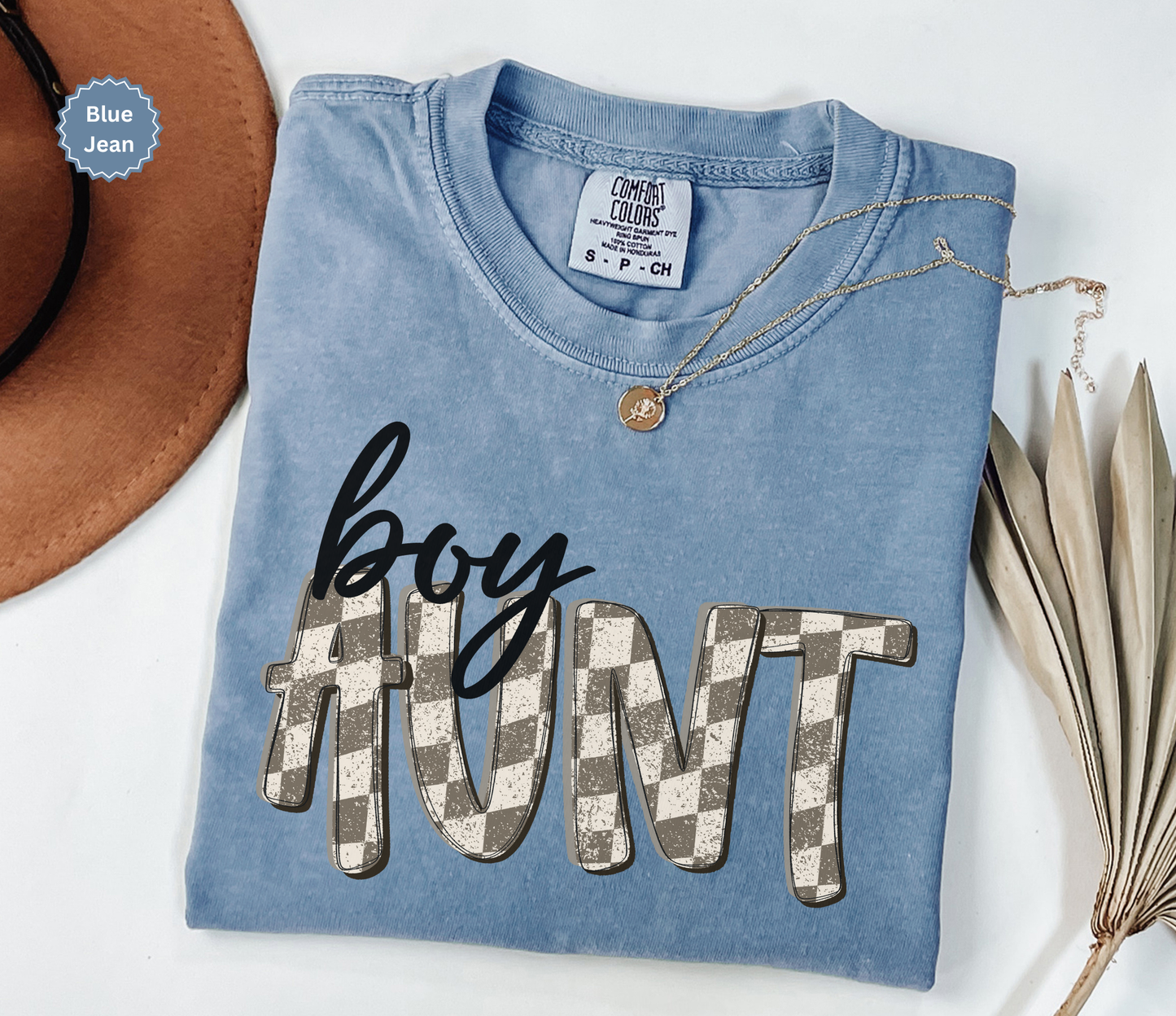 folded blue jean colored comfort colors t-shirt with retro checkered 'boy aunt' text.