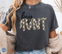 Load image into Gallery viewer, Woman wearing a dark grey pepper comfort colors t-shirt with retro checkered 'boy aunt' text.
