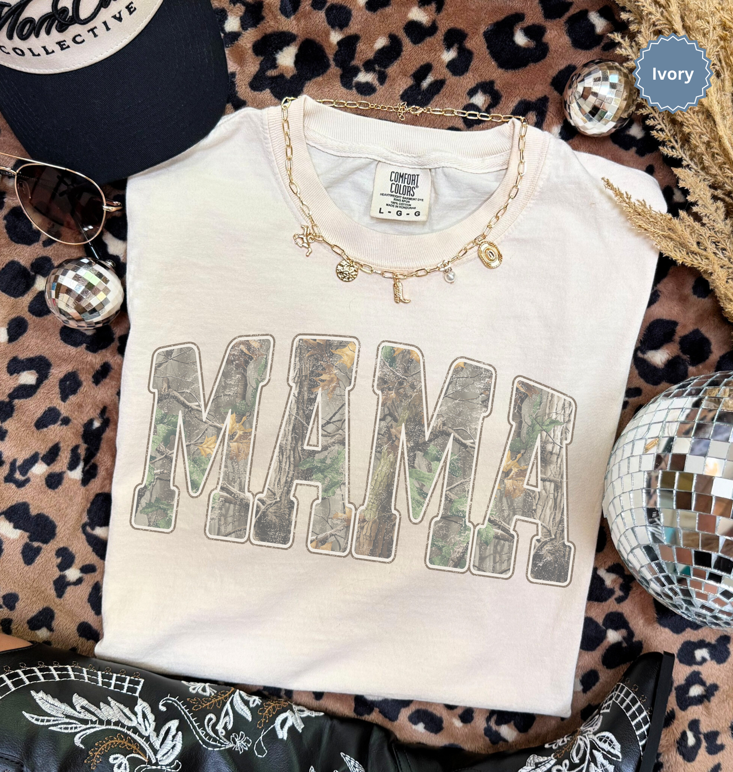 Comfort colors ivory t-shirt with distressed 'MAMA' in camo print text.