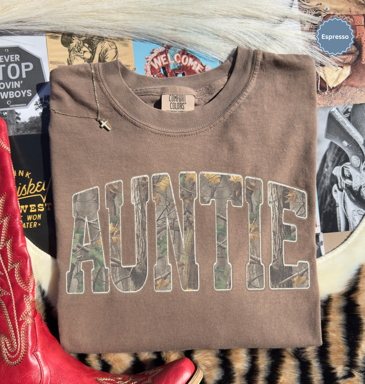 Folded comfort colors espresso brown t-shirt with 'AUNTIE' printed in distressed camo.