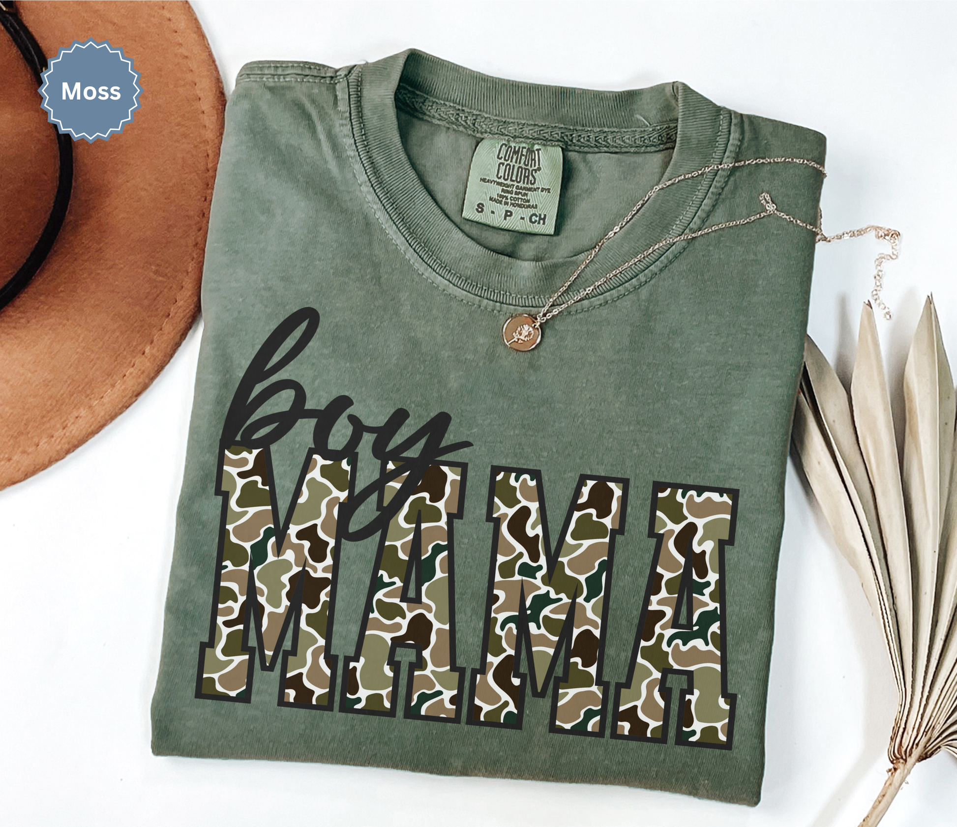 Comfort colors moss green t-shirt with 'MAMA' in duck camo print text.