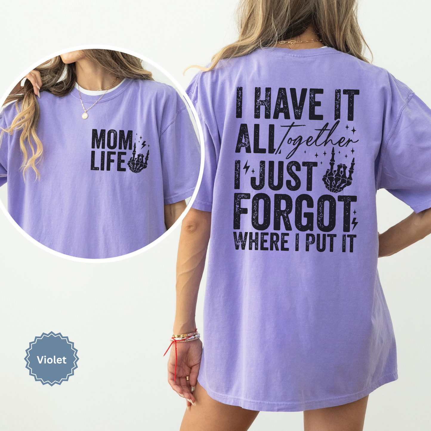Woman wearing a violet comfort colors t-shirt with 'Mom Life' of the front pocket and 'I Have It All Together I just forgot where I put it' text on the back.