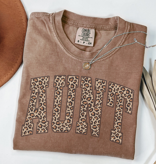 Comfort Colors espresso Brown t-shirt with leopard print 'AUNT' varsity text.