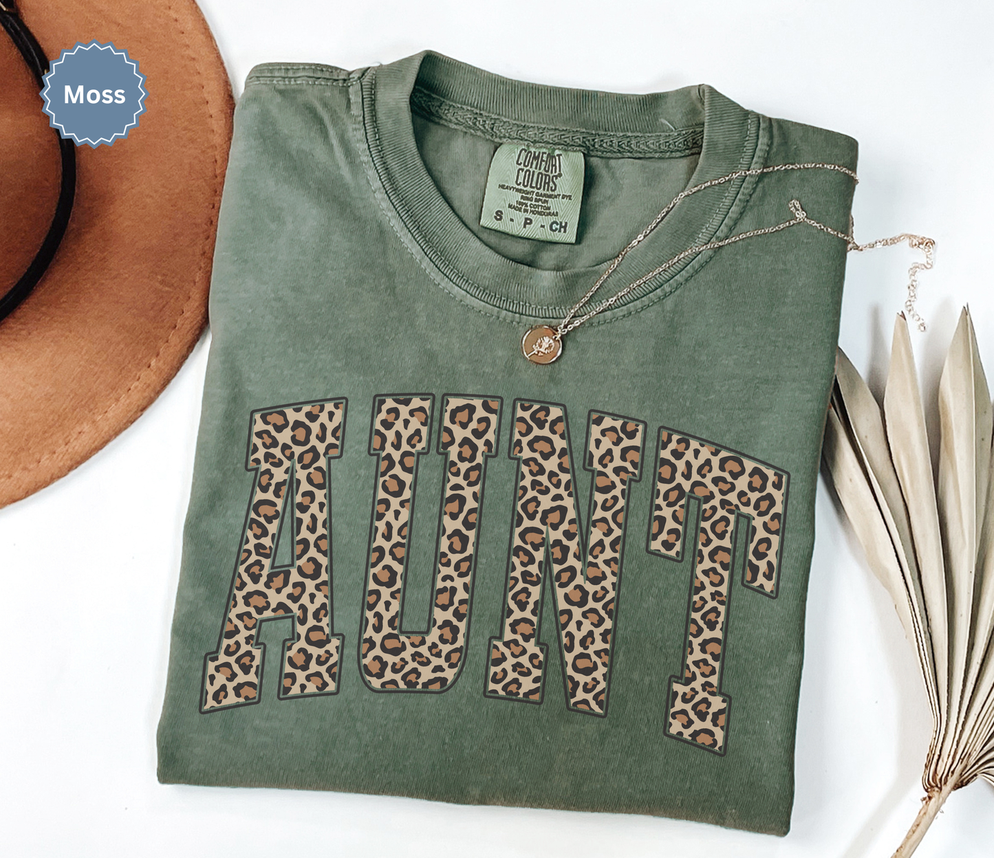 Comfort Colors moss green t-shirt with leopard print 'AUNT' varsity text.