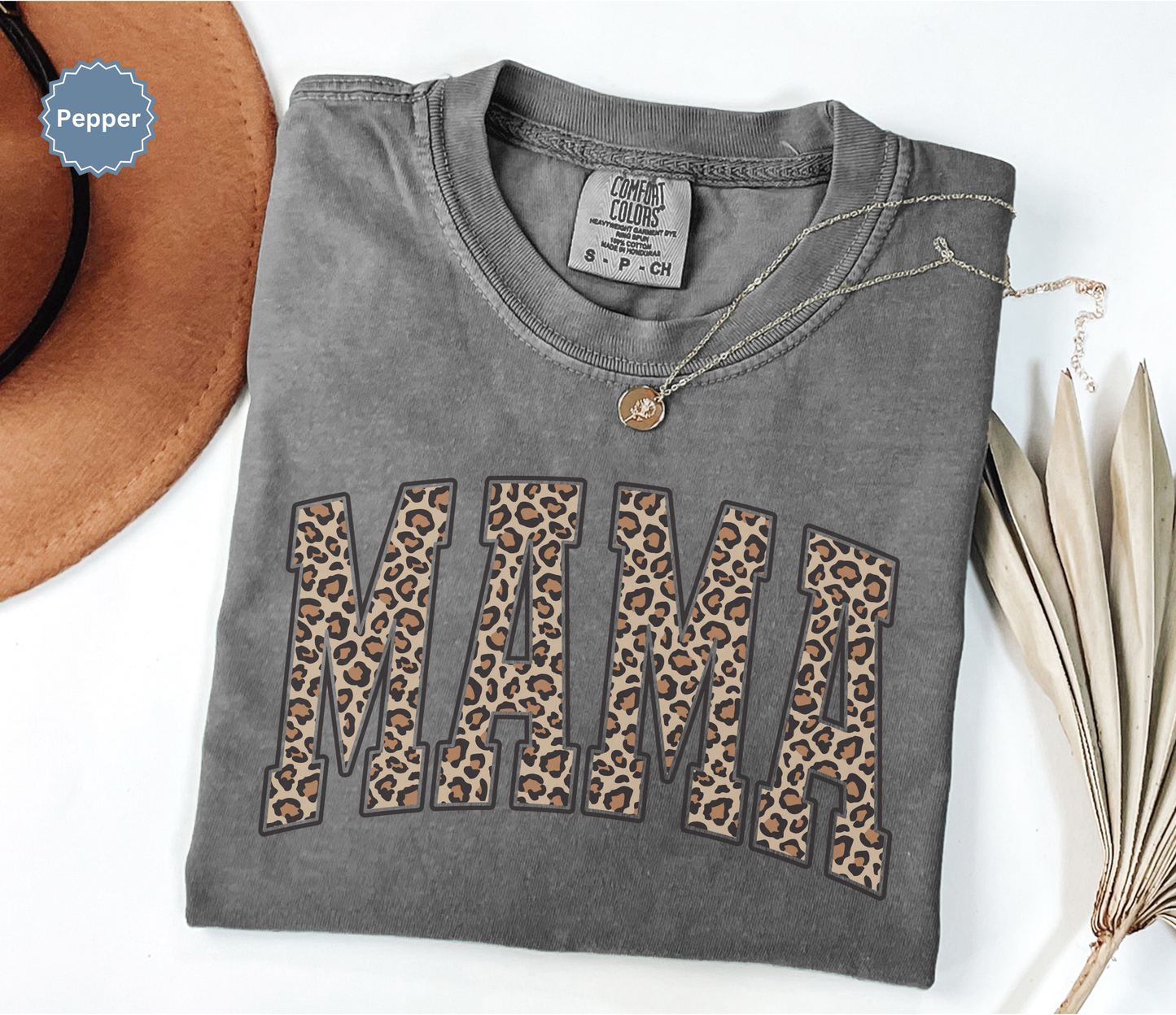Folded dark gray comfort colors t-shirt with 'MAMA' in leopard print.