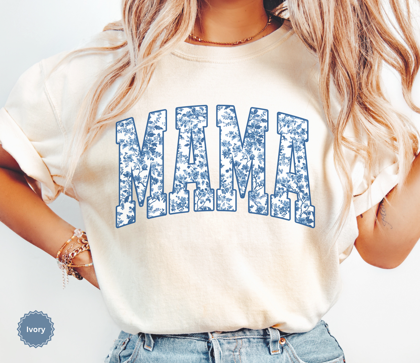 Woman wearing an ivory t-shirt with 'MAMA' toile floral print design.