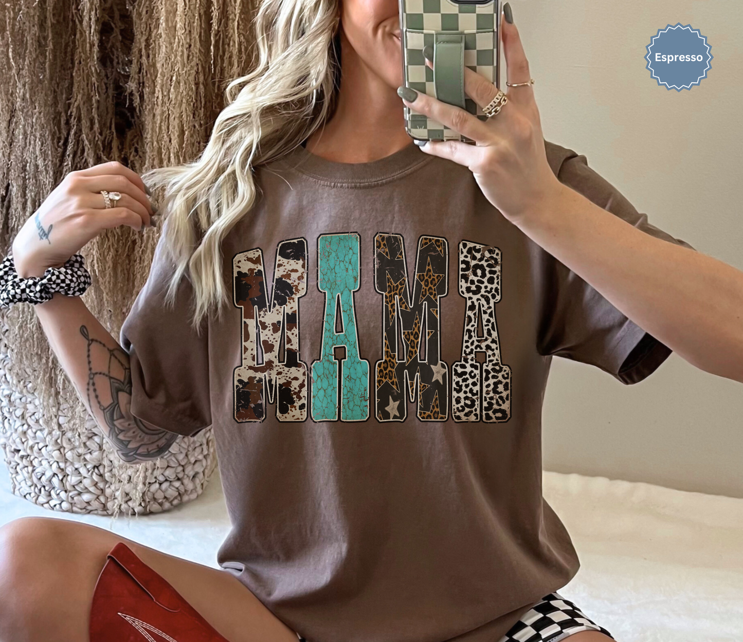 Woman wearing a comfort colors espresso brown t-shirt with western inspired 'MAMA' text.
