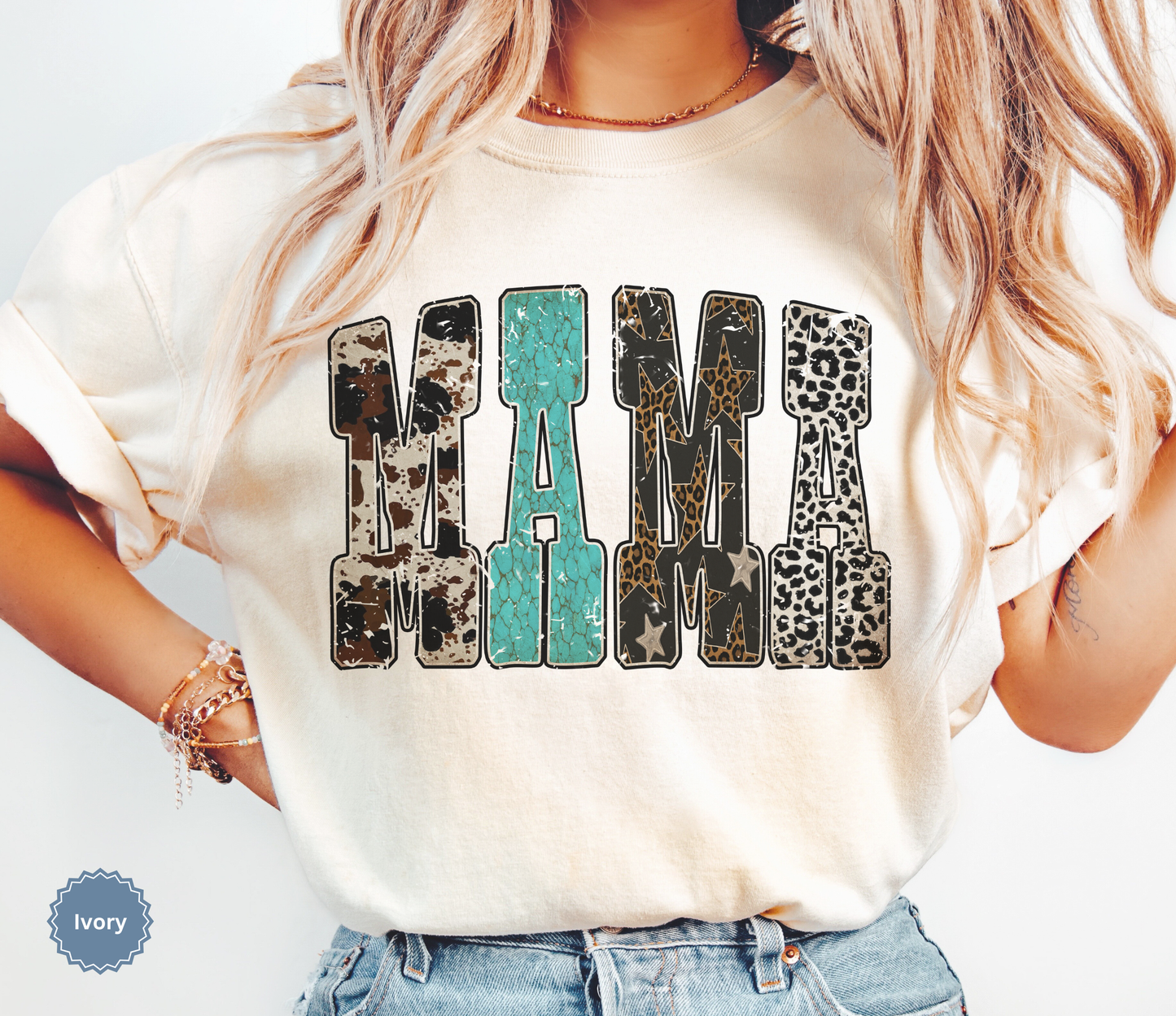 Woman wearing a comfort colors ivory t-shirt with western inspired 'MAMA' text.