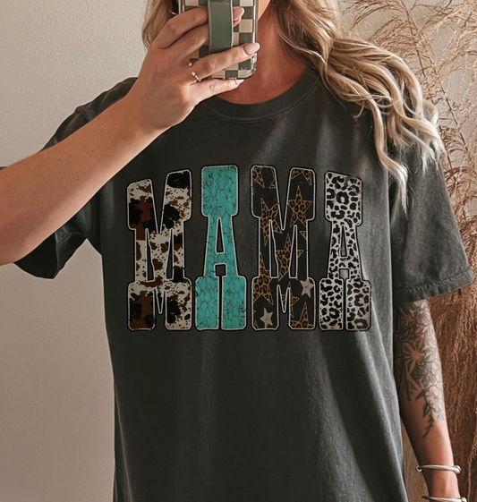 Woman wearing a comfort colors dark gray pepper t-shirt with western inspired 'MAMA' text.