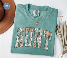 Load image into Gallery viewer, Comfort colors seafoam t-shirt with floral 'AUNT' varsity text
